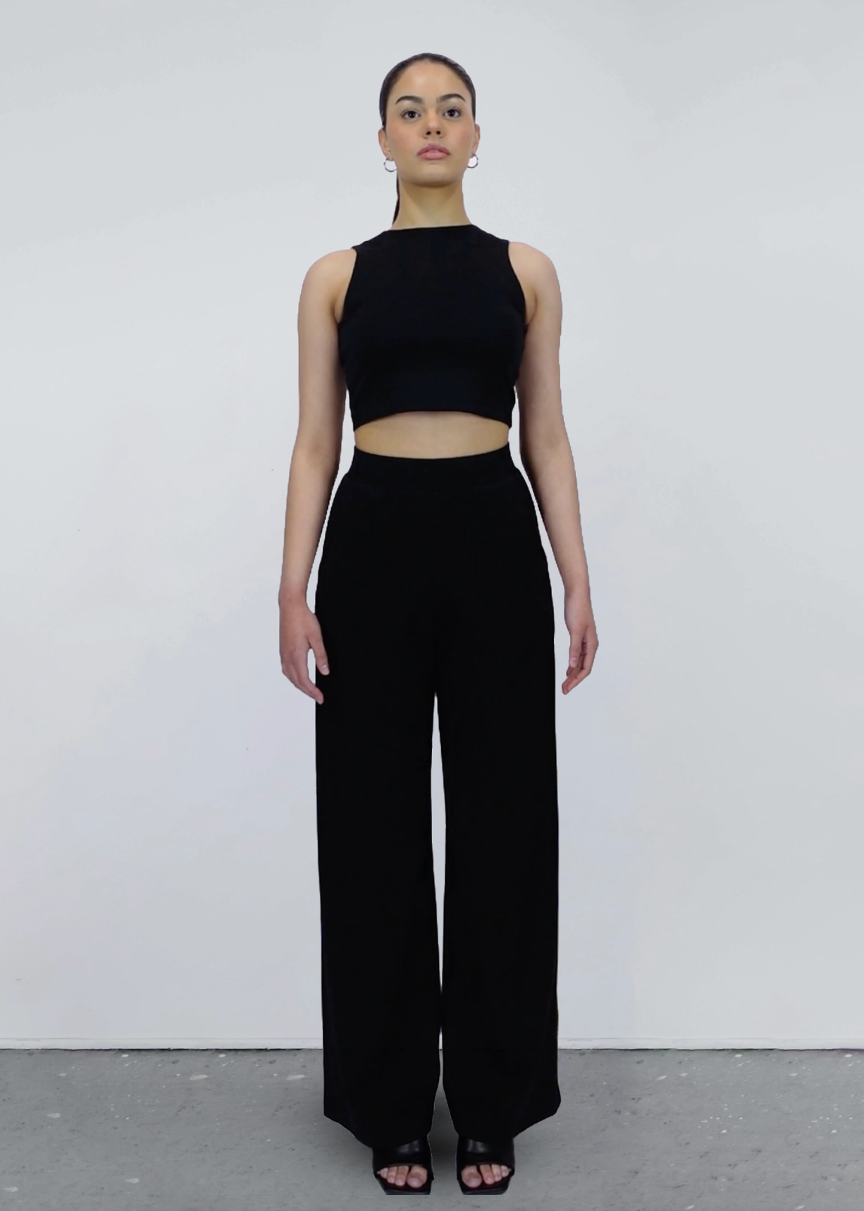 black sleeveless crop top and black wide-leg pants